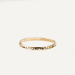 Gold filled ring on a light beige background