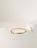 Gold filled ring on a white stone background