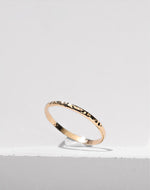 Gold filled ring on a white stone background