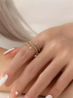 Gold filled twisted ring with moissanite accents on a models hand