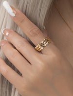 3 Gold filled rings with small round beads and a central moissanite on a models hand