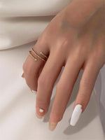 Gold filled twisted ring with moissanite accents on a models hand