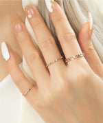 Model's hand showcasing 4 of these gold filled rings