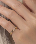 Gold filled ring with small round beads and a central moissanite on a models hand