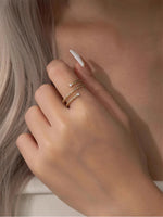 Gold filled twisted ring with moissanite accents on a model's hand