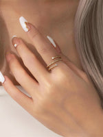 Gold filled twisted ring with moissanite accents on a model's hand