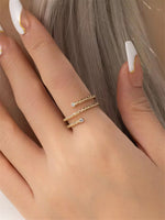 Gold filled twisted ring with moissanite accents on a models hand