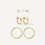 Set of gold hoop earrings on a white background