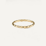 Gold filled ring with a textured band on a white background