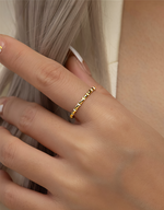 Close-up of a hand wearing a gold filled ring