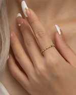 Close-up of a hand wearing a gold filled ring