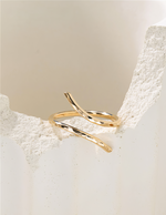 Gold filled ring on a textured beige surface