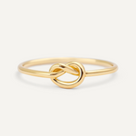 Gold filled knot ring on a light beige background