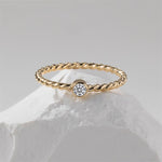 A gold filled ring on a white stone