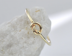 Gold filled ring on a stone cone with white background