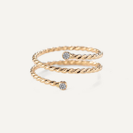 Gold filled twisted ring with moissanite accents on a white background