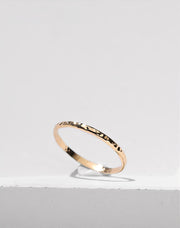 Gold filled ring on a white stone background
