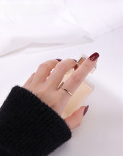 Gold filled ring on model's hand on a white cloth background