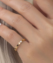 Gold filled ring with small round beads and a central moissanite on a models hand