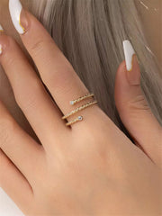 Gold filled twisted ring with moissanite accents on a models hand