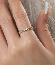Gold filled ring with small round beads and a central moissanite on a models hand