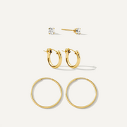 Set of gold hoop earrings on a white background