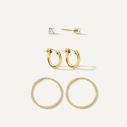 Set of gold hoop earrings on a white background