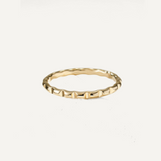 Gold filled ring with a textured band on a white background