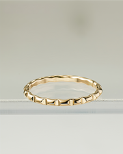 Gold filled ring with a textured band on a light gray background