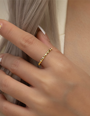 Close-up of a hand wearing a gold filled ring