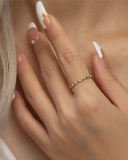 Close-up of a hand wearing a gold filled ring
