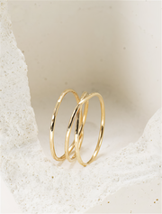Gold filled ring on a textured beige surface
