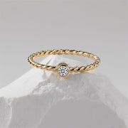 A gold filled ring on a white stone